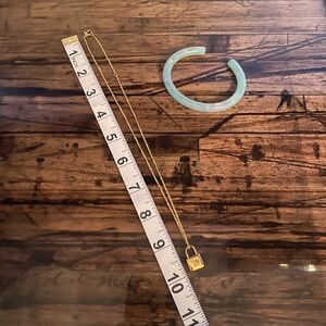 Necklace with L charm and green/white iridescent bracelet.